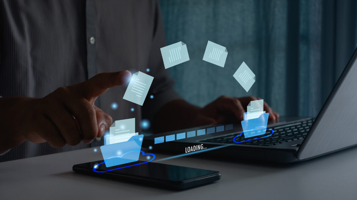 Transfer data document file folder to cloud using ai technology with online system for backup storage on mobile phone and laptop. Businessman hand touch on document for send of document on internet.